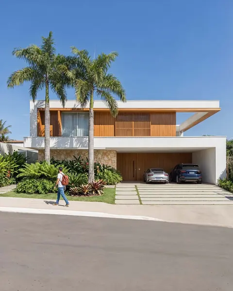 White facade with palm trees on the street